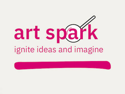 The words art spark are in pink. The 'a' in spark is surrounded by a magnifying glass. Underneath, in pink, it says 'ignite ideas and imagine' and this is underlined by a bold, pink line.