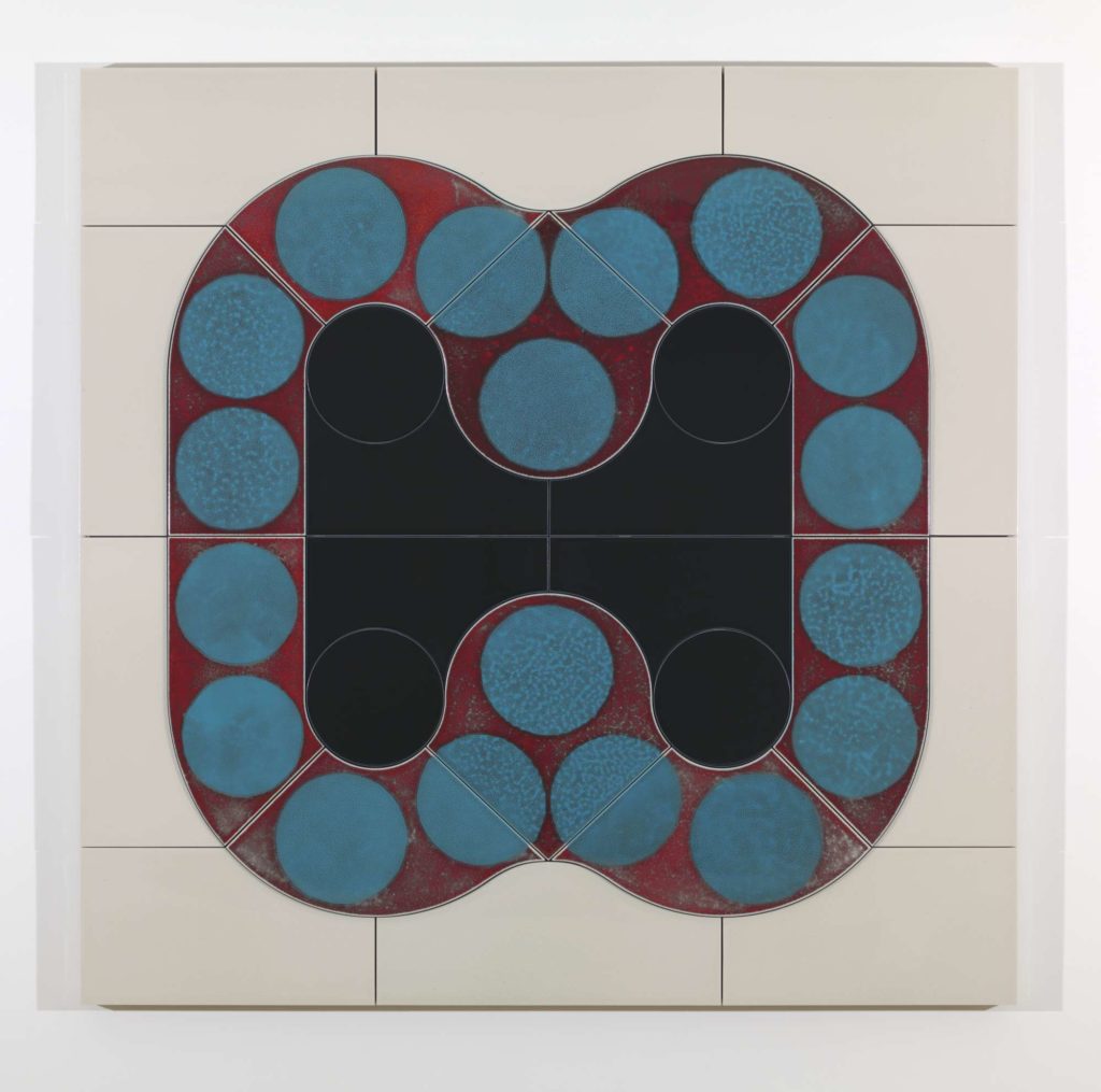 A red line that forms an m shape and is mirrored below itself, with 18 solid blue circles set against it, all this i set against cream-coloured ceramic tiles.